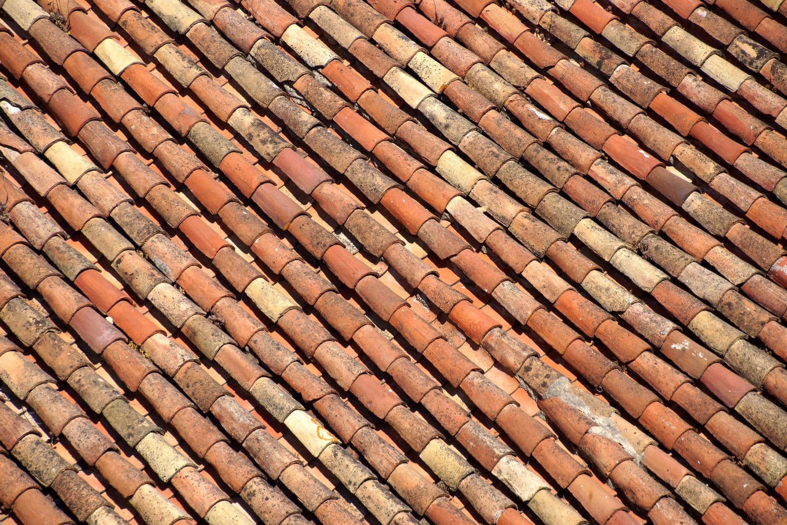 Old, weathered roof tiles before